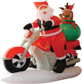 Santa riding a red motorcycle with a reindeer holding a gift sack behind him