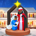 Nativity inflatable with a Black Holy Family under a dark stable roof with a gold star in a snowy yard