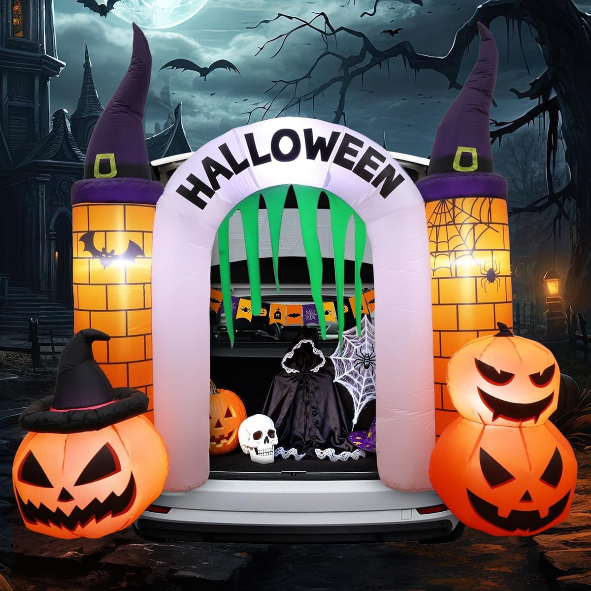 Small Halloween castle arch inflatable with pumpkins and witch-hat turrets framing a car trunk