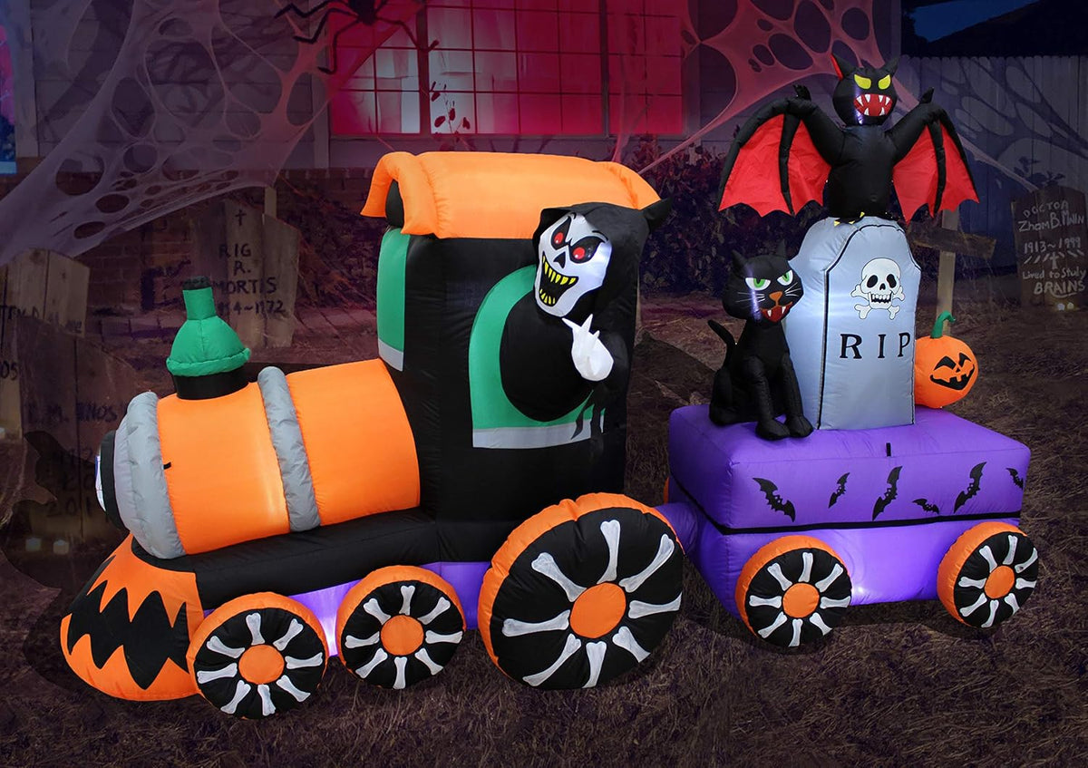Halloween train inflatable with a grim reaper driving and a cat, bat and tombstone in the car