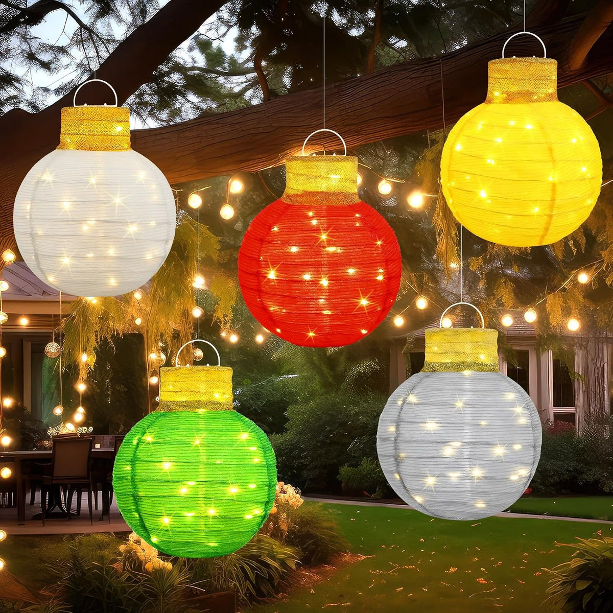 Five lighted pop-up Christmas ornament balls in white, red, yellow, green and silver hanging from a tree
