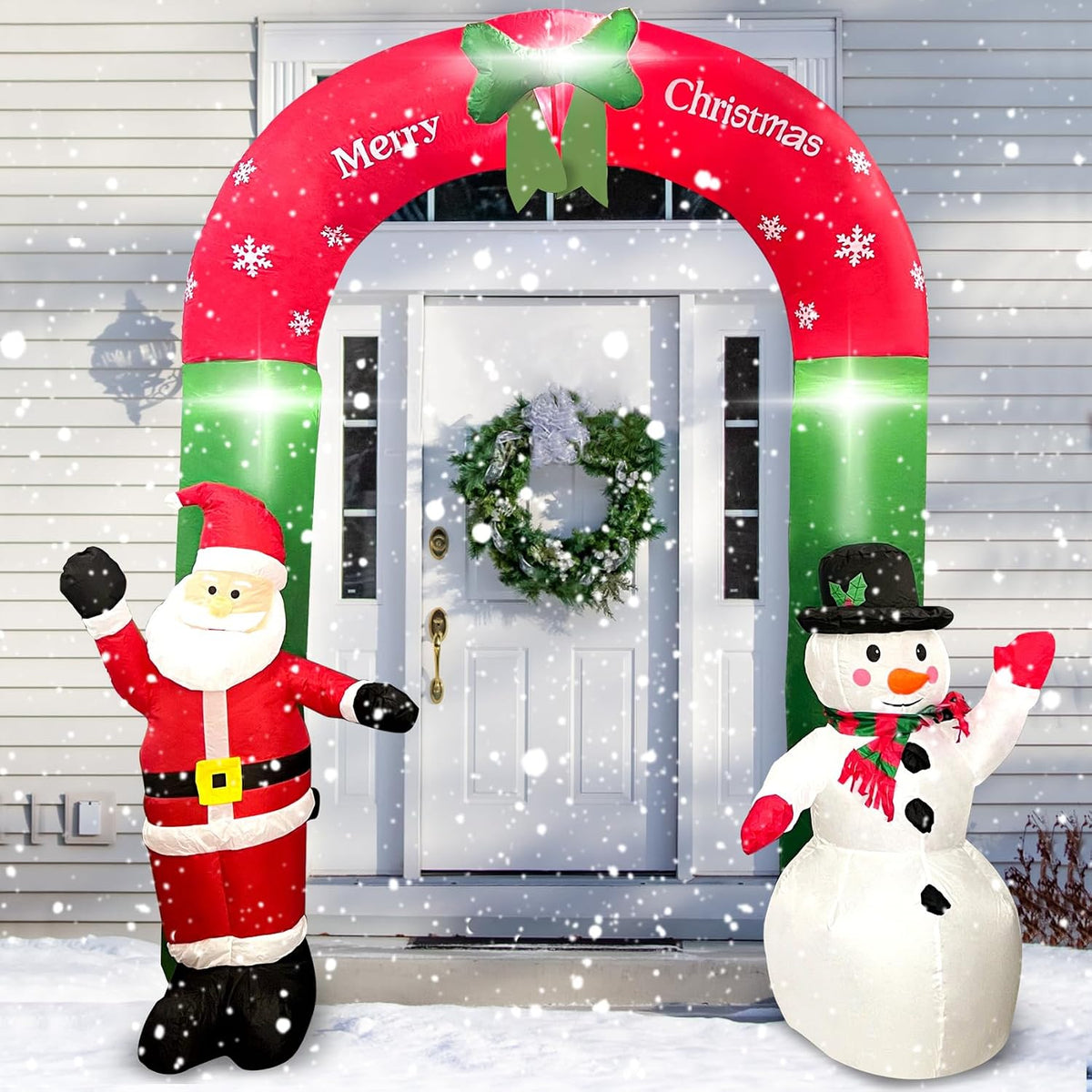 Red Merry Christmas arch inflatable with Santa and a snowman at each side in front of a door