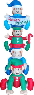 Tower of four stacked elf inflatables with the top elf holding a Season's Greetings banner