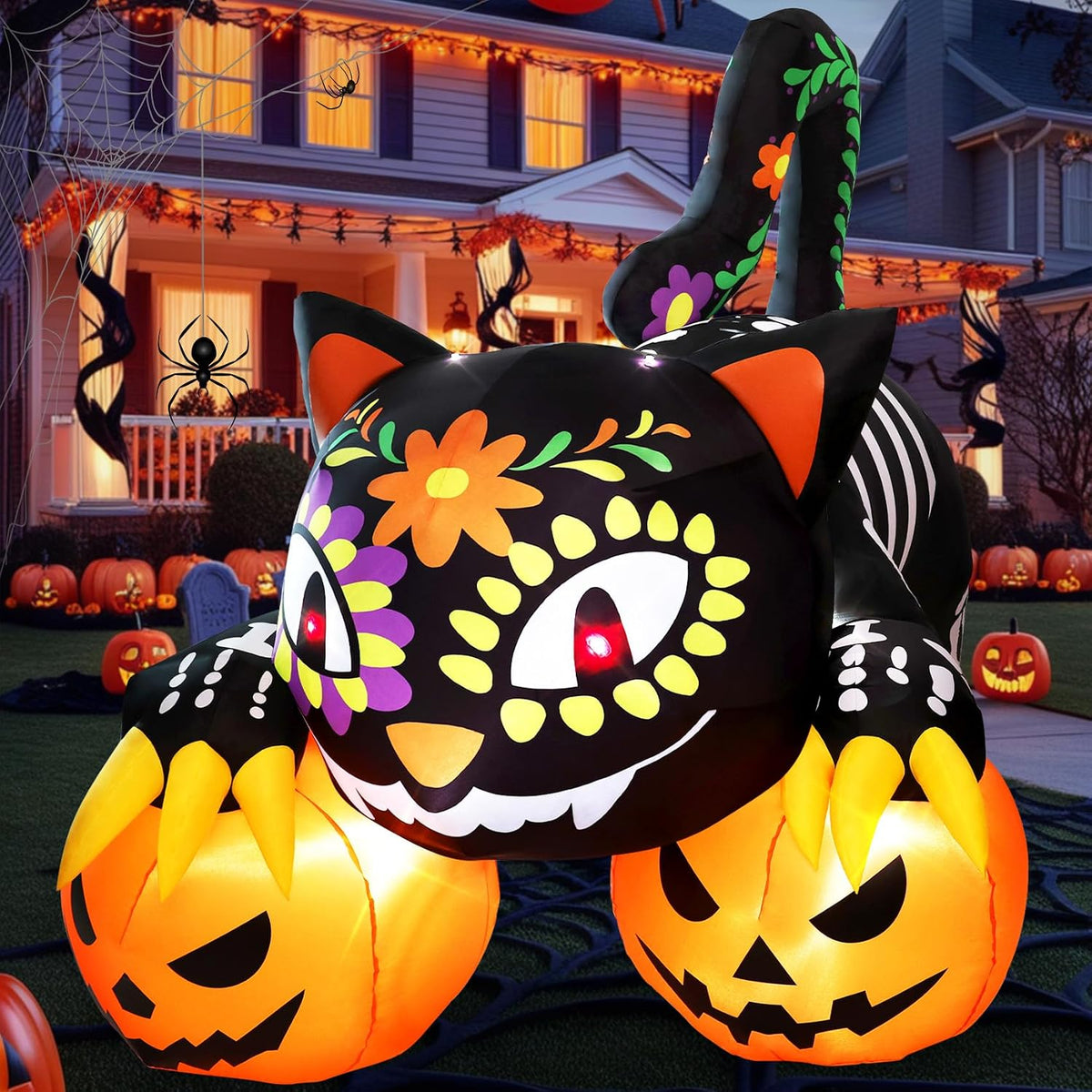 Black cat with a sugar-skull face pattern over two glowing jack-o'-lanterns in a Halloween yard