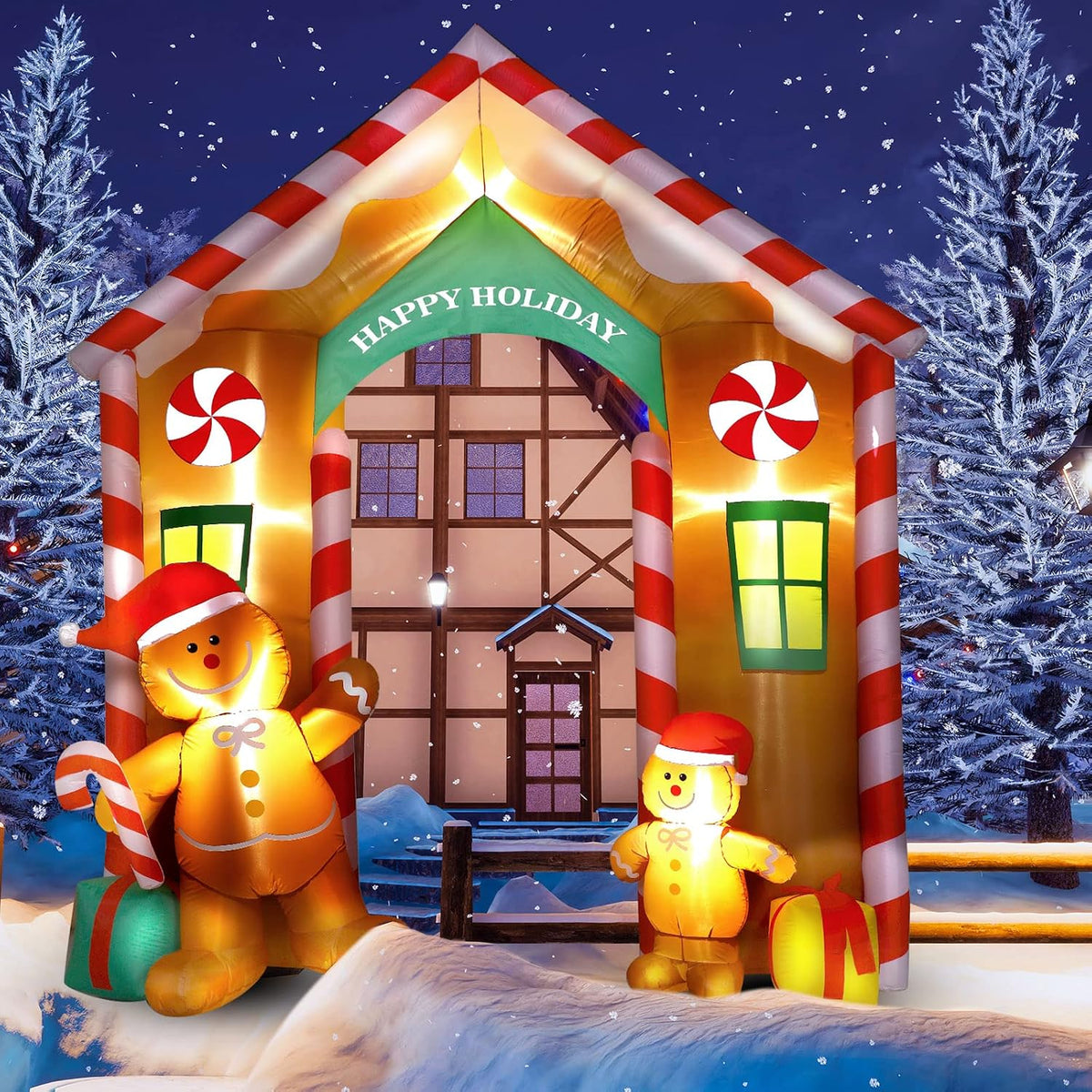 Gingerbread cookie house arch inflatable with a Happy Holiday sign and gingerbread figures in the snow