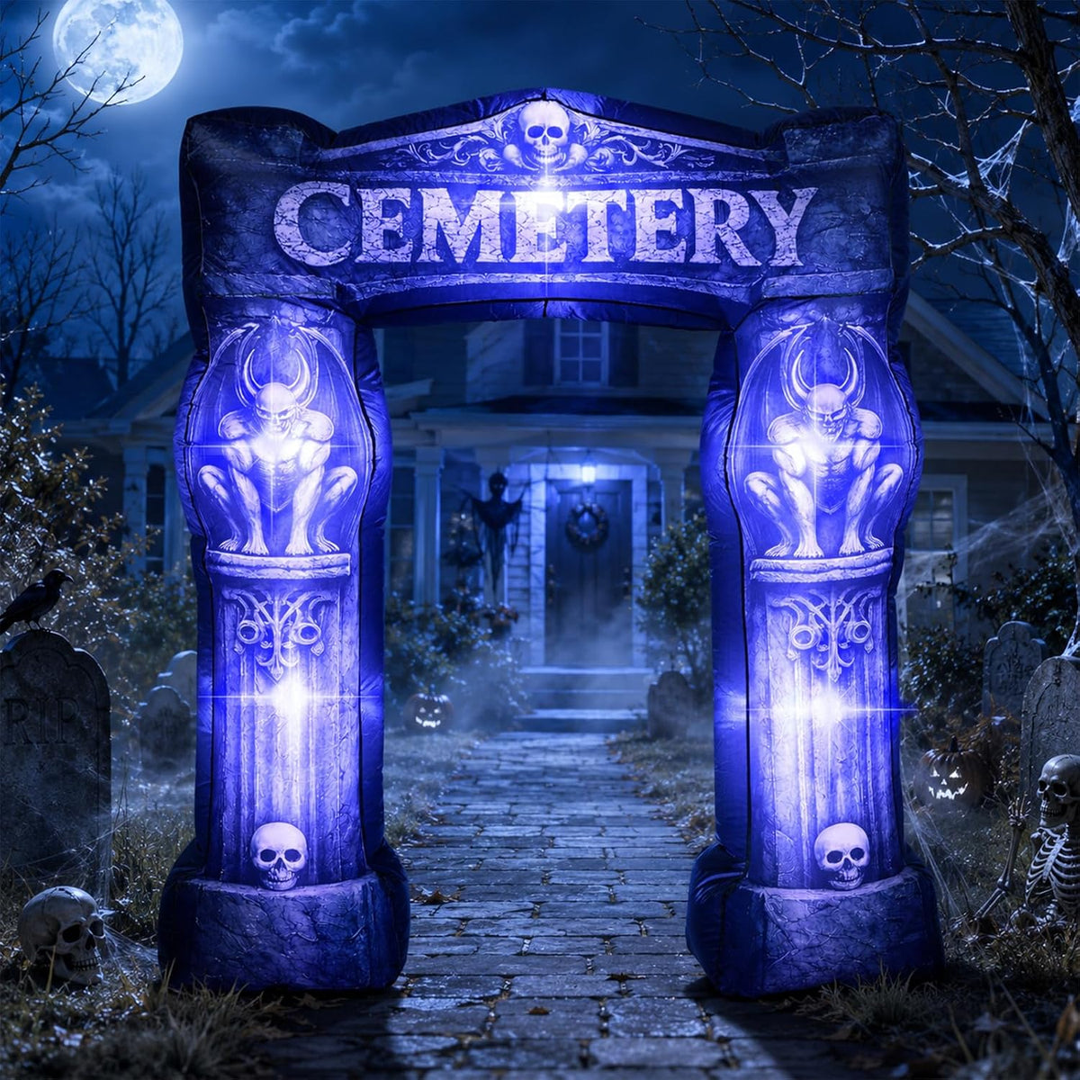 Gothic cemetery gate inflatable arch with skull pillars lit blue at night
