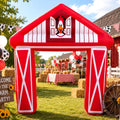 Red barn inflatable arch with white trim at a farm-themed backyard party