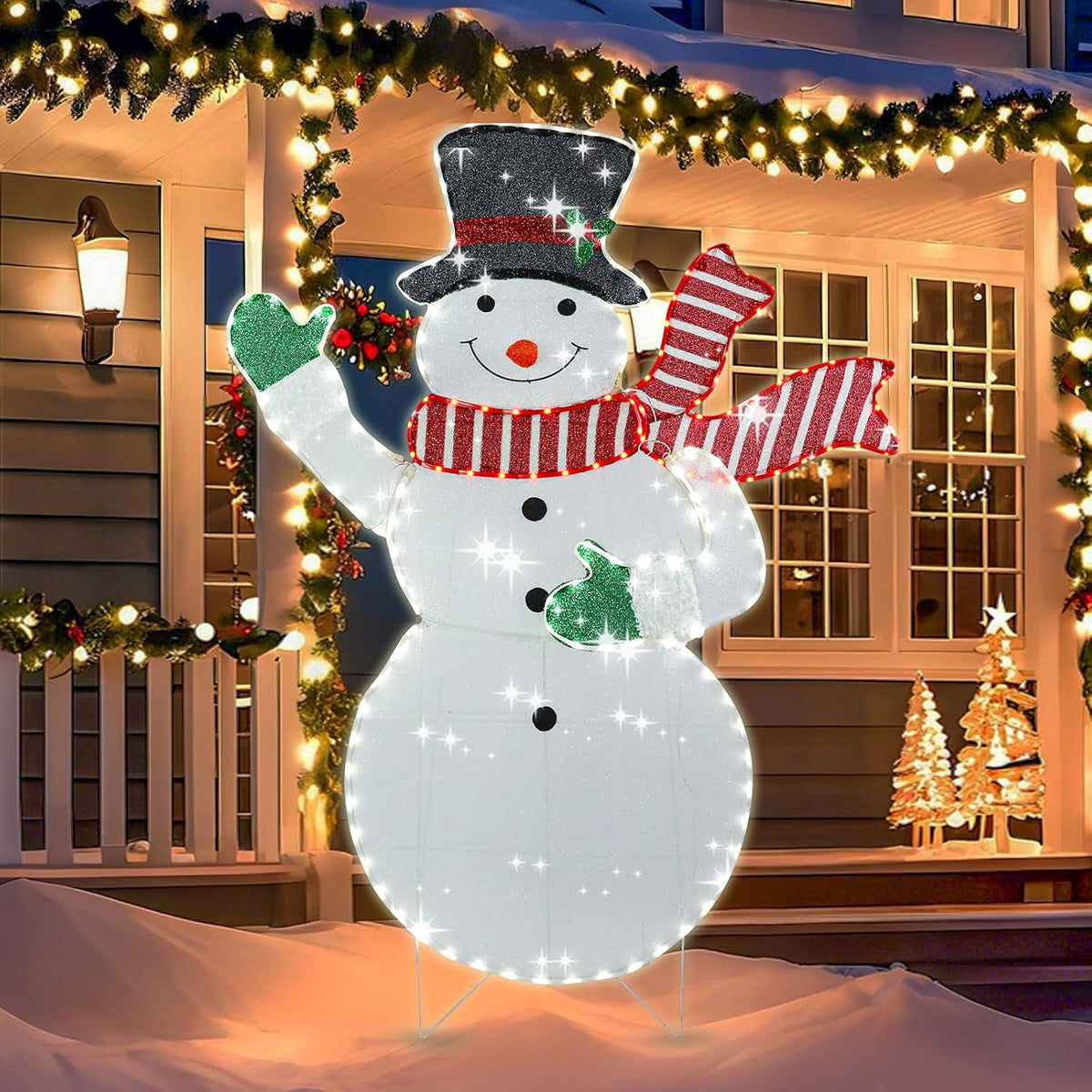Glittering lighted snowman with a black top hat and red striped scarf in front of a porch