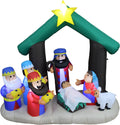 Nativity inflatable with the Holy Family, three kings and a sheep under a green stable roof with a star